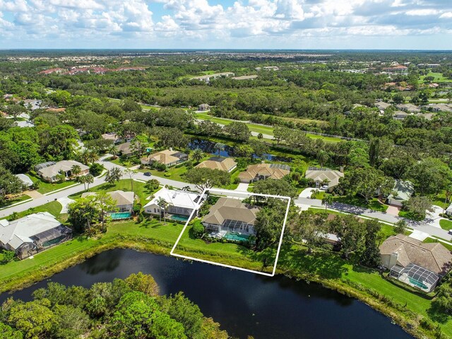 8687 Woodbriar Dr, Sarasota, FL 34238 - aerial perspective of suburban area with property parcel outlined and a large body of water