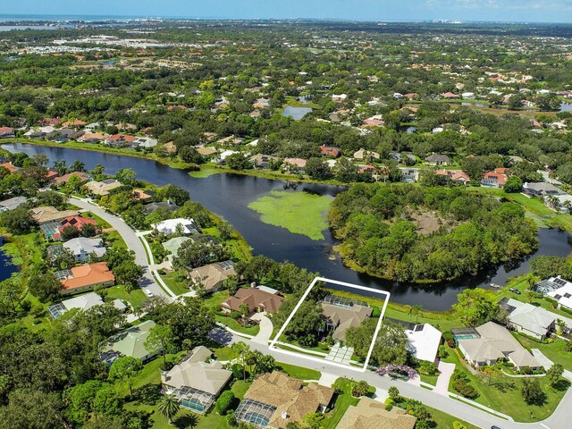 8687 Woodbriar Dr, Sarasota, FL 34238 - aerial overview of property's location featuring a large body of water, property boundaries highlighted, and nearby suburban area