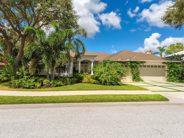 8687 Woodbriar Dr, Sarasota, FL 34238 - view of front of home featuring a garage, driveway, and stucco siding