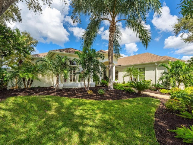 8687 Woodbriar Dr, Sarasota, FL 34238 - mediterranean / spanish-style home with stucco siding and a front yard
