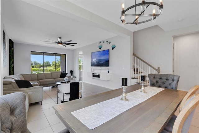 8355 Velda Trl, Sarasota, FL 34241 - dining area with light tile patterned floors, a chandelier, stairway, and a ceiling fan