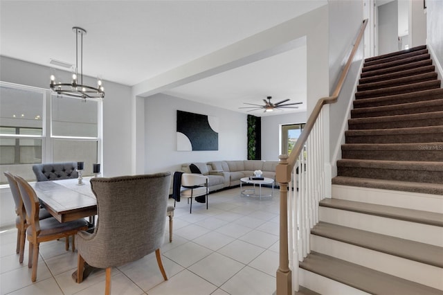 8355 Velda Trl, Sarasota, FL 34241 - dining room featuring stairs, light tile patterned floors, a chandelier, and a ceiling fan