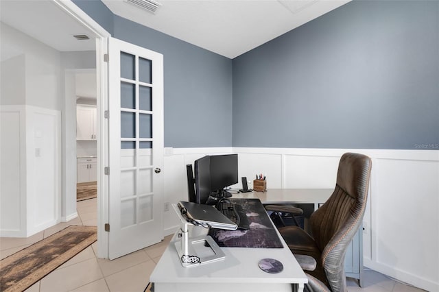 8355 Velda Trl, Sarasota, FL 34241 - office area featuring light tile patterned floors and a wainscoted wall