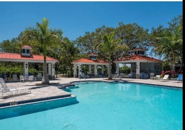 pool featuring a gazebo and a patio area