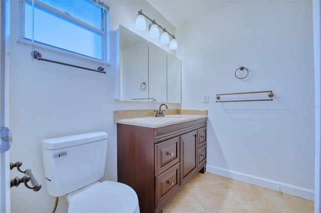 bathroom with tile patterned floors, toilet, vanity, and baseboards