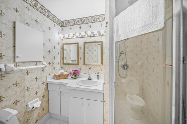bathroom with a stall shower, wallpapered walls, vanity, and toilet