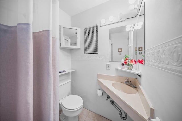 full bath with tile patterned flooring, a sink, and toilet
