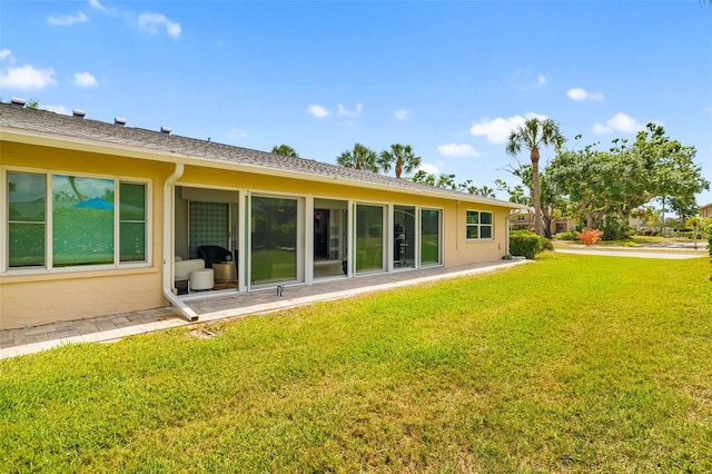 6940 W Country Club Dr N Unit V-77, Sarasota, FL 34243 - rear view of house featuring a lawn and stucco siding