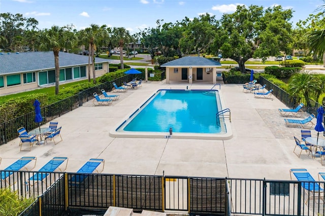 6940 W Country Club Dr N Unit V-77, Sarasota, FL 34243 - community pool featuring a patio area and fence