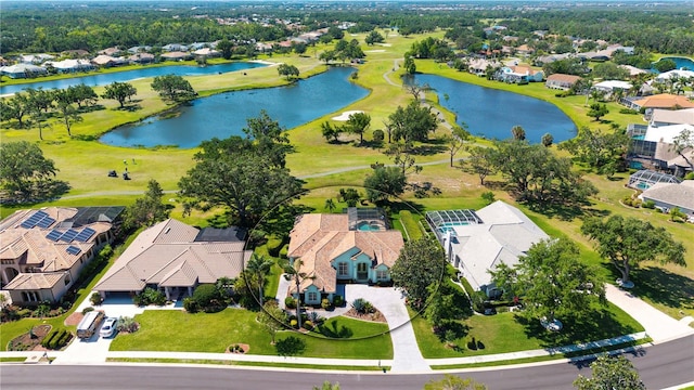 aerial view of residential area with a large body of water and a local golf course