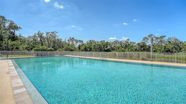 community pool featuring fence