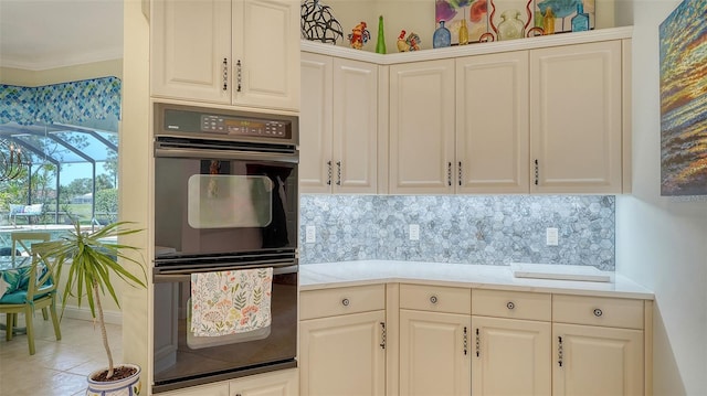 kitchen featuring decorative backsplash, light countertops, crown molding, and white cabinetry