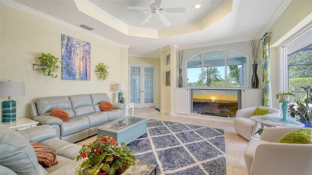 living area featuring crown molding, a tray ceiling, ceiling fan, french doors, and recessed lighting