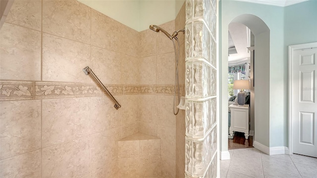 full bathroom with a tile shower and tile patterned flooring