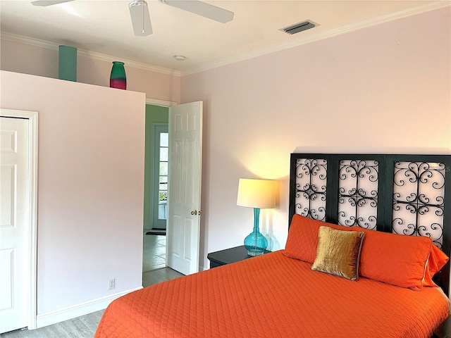 bedroom featuring wood finished floors, crown molding, ceiling fan, and baseboards