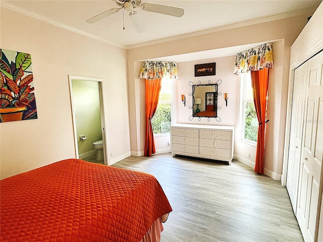 bedroom with ornamental molding, wood finished floors, baseboards, ceiling fan, and ensuite bathroom