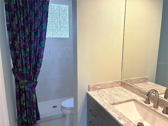 full bath with a textured wall, a shower stall, toilet, and vanity
