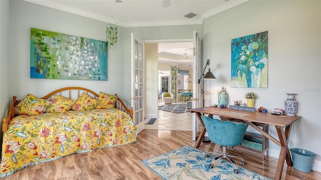 bedroom with ornamental molding, baseboards, wood finished floors, french doors, and ceiling fan