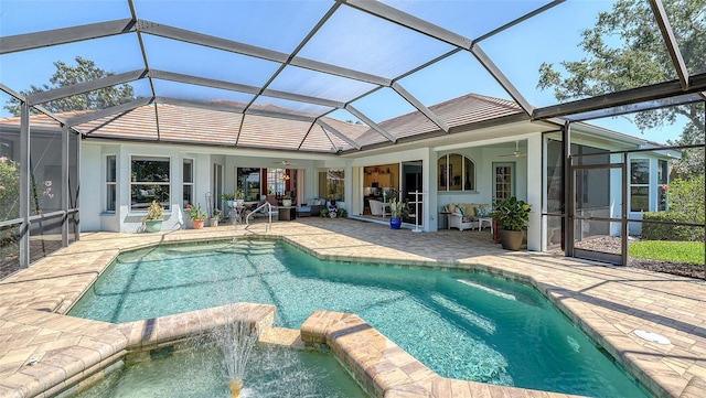 back of house featuring ceiling fan, a patio area, a pool with connected hot tub, stucco siding, and a lanai