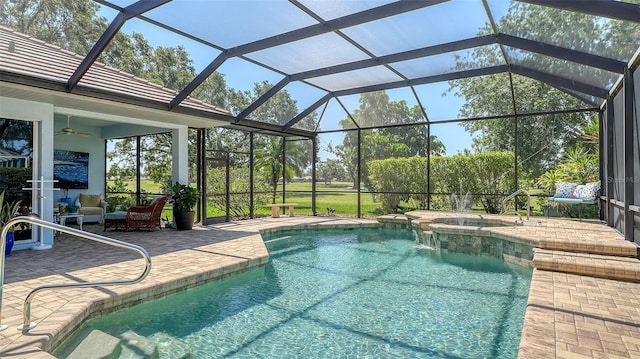 swimming pool featuring a patio, an in-ground hot tub, a ceiling fan, and a lanai