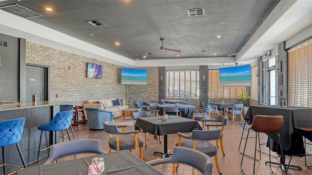 lobby featuring brick wall and recessed lighting