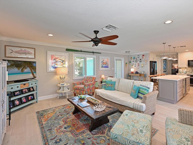 10016 Spoonbill Rd E, Bradenton, FL 34209 - living room with visible vents, ceiling fan, light wood-style floors, a textured ceiling, and crown molding