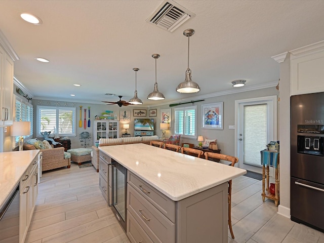 10016 Spoonbill Rd E, Bradenton, FL 34209 - kitchen with open floor plan, black fridge with ice dispenser, visible vents, a breakfast bar area, and dishwasher