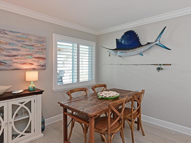 10016 Spoonbill Rd E, Bradenton, FL 34209 - dining space with crown molding, baseboards, and light wood-style floors