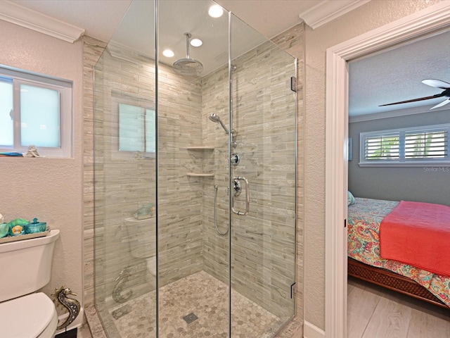 10016 Spoonbill Rd E, Bradenton, FL 34209 - ensuite bathroom featuring ornamental molding, a stall shower, a textured wall, ensuite bathroom, and toilet