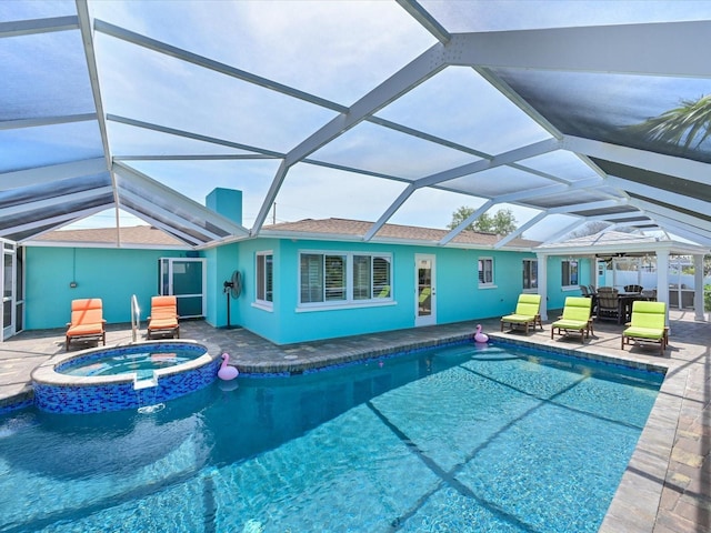 10016 Spoonbill Rd E, Bradenton, FL 34209 - view of swimming pool with a patio area, a pool with connected hot tub, and glass enclosure