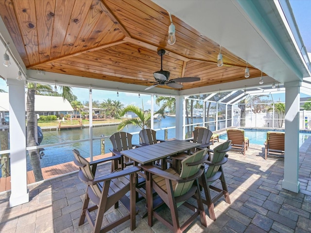 10016 Spoonbill Rd E, Bradenton, FL 34209 - view of patio / terrace featuring a water view, ceiling fan, a fenced in pool, and a lanai