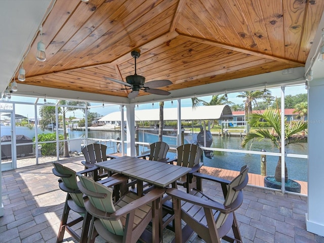 10016 Spoonbill Rd E, Bradenton, FL 34209 - view of patio featuring boat lift, a dock, a lanai, ceiling fan, and a water view