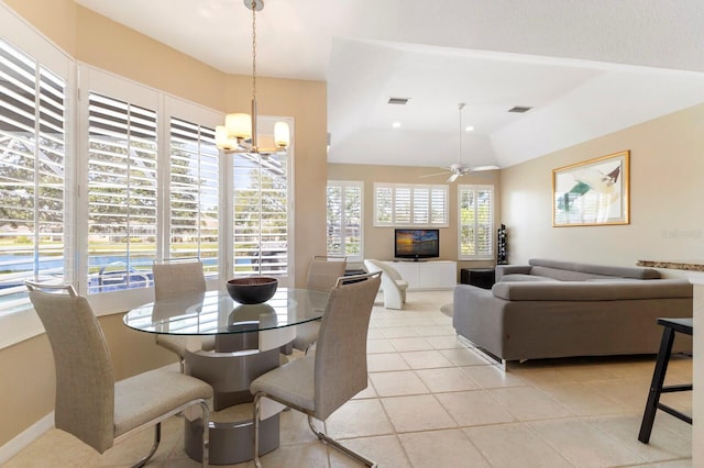 dining space featuring light tile patterned floors, visible vents, ceiling fan with notable chandelier, and lofted ceiling