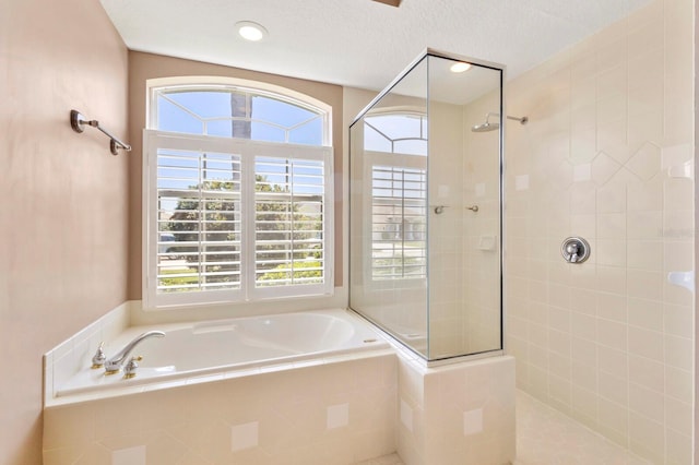 full bath with a garden tub and tiled shower