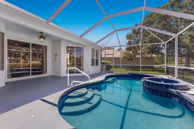 view of swimming pool with a ceiling fan, a lanai, a pool with connected hot tub, and a patio area