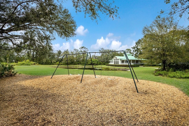view of property's community with a yard and playground community