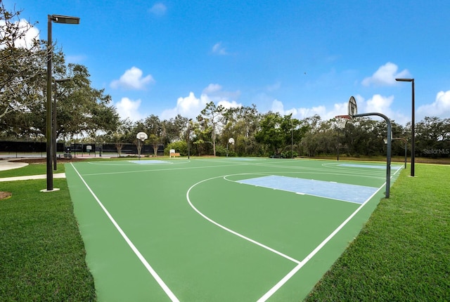 view of basketball court featuring a lawn and community basketball court