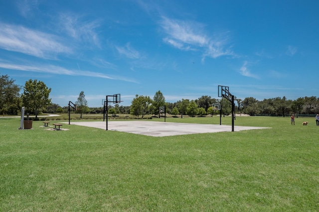 view of basketball court featuring a lawn and community basketball court