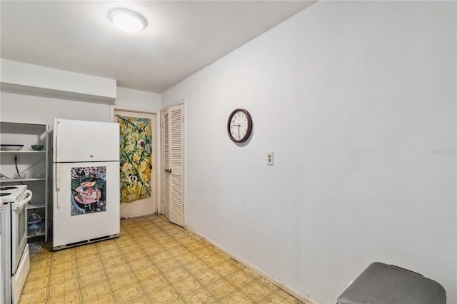 kitchen featuring white appliances and light floors