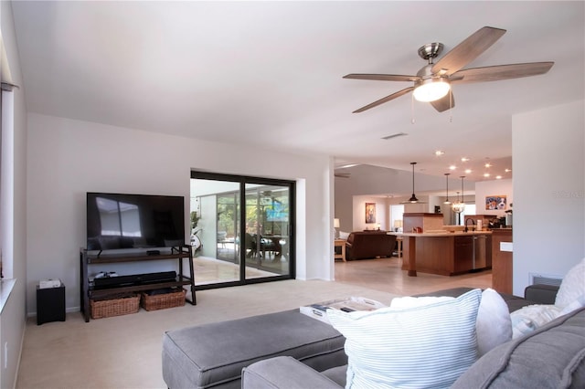 living room featuring a ceiling fan and light carpet