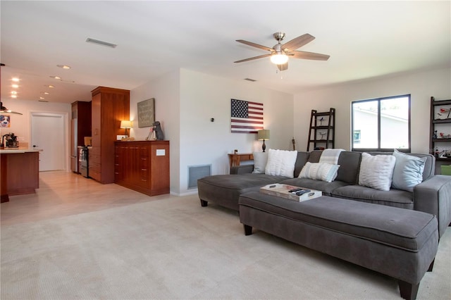 living room featuring a ceiling fan, light carpet, recessed lighting, and baseboards