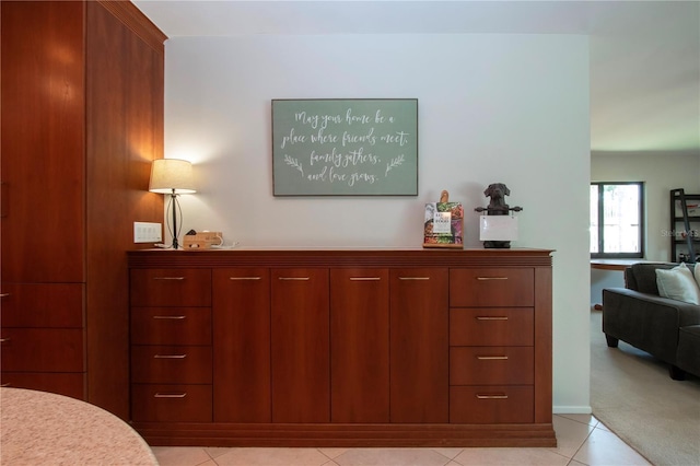 bedroom featuring light tile patterned flooring and baseboards