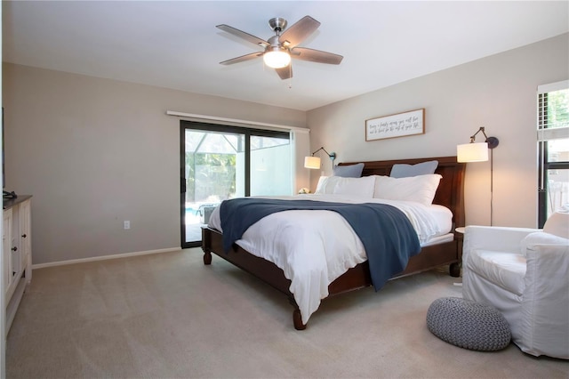bedroom with baseboards, light colored carpet, a ceiling fan, and access to outside