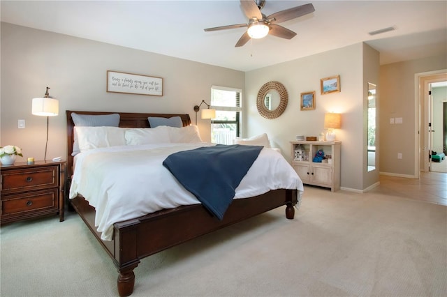 bedroom featuring light carpet, ceiling fan, and baseboards