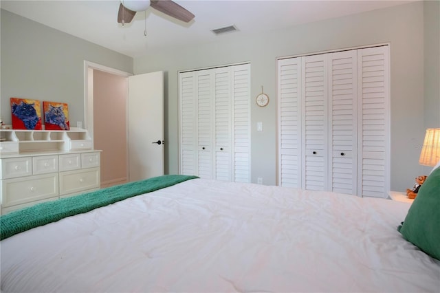 bedroom featuring two closets and ceiling fan