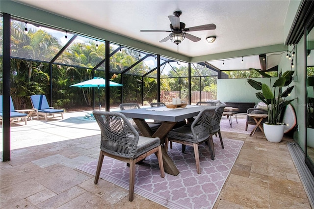 sunroom featuring ceiling fan and outdoor dining space
