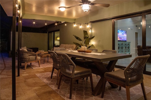 dining space featuring track lighting and ceiling fan