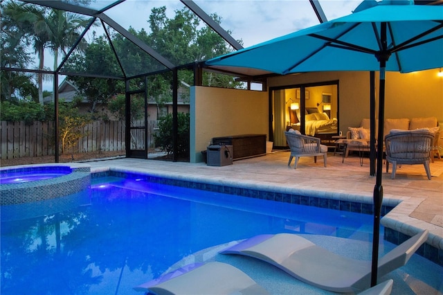 view of swimming pool with a patio, an outdoor living space, a lanai, fence, and a pool with connected hot tub