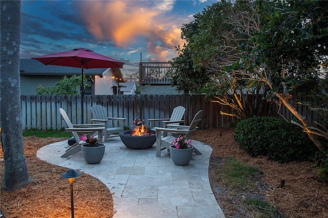 view of patio / terrace featuring a fire pit and fence