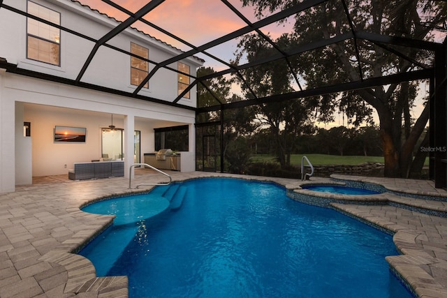 7532 Greystone St, Lakewood Ranch, FL 34202 - pool at dusk with a patio, a pool with connected hot tub, a ceiling fan, a lanai, and outdoor lounge area